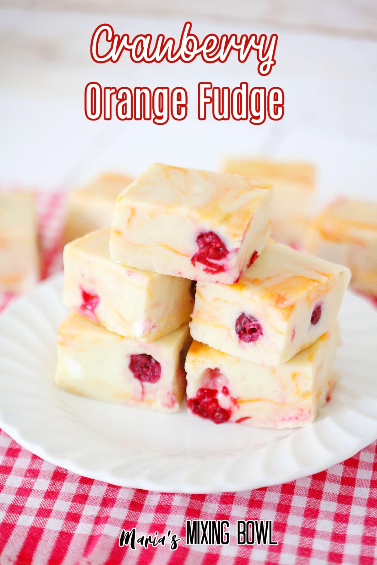 stack of cranberry orange fudge on a white plate