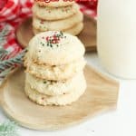 four cream cheese sugar cookies on a wooden cutting board with the name in text