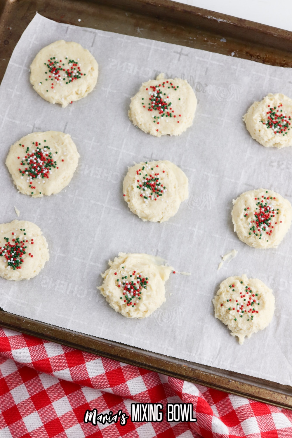 dough topped with sprinkles on a parchment lined baking sheet
