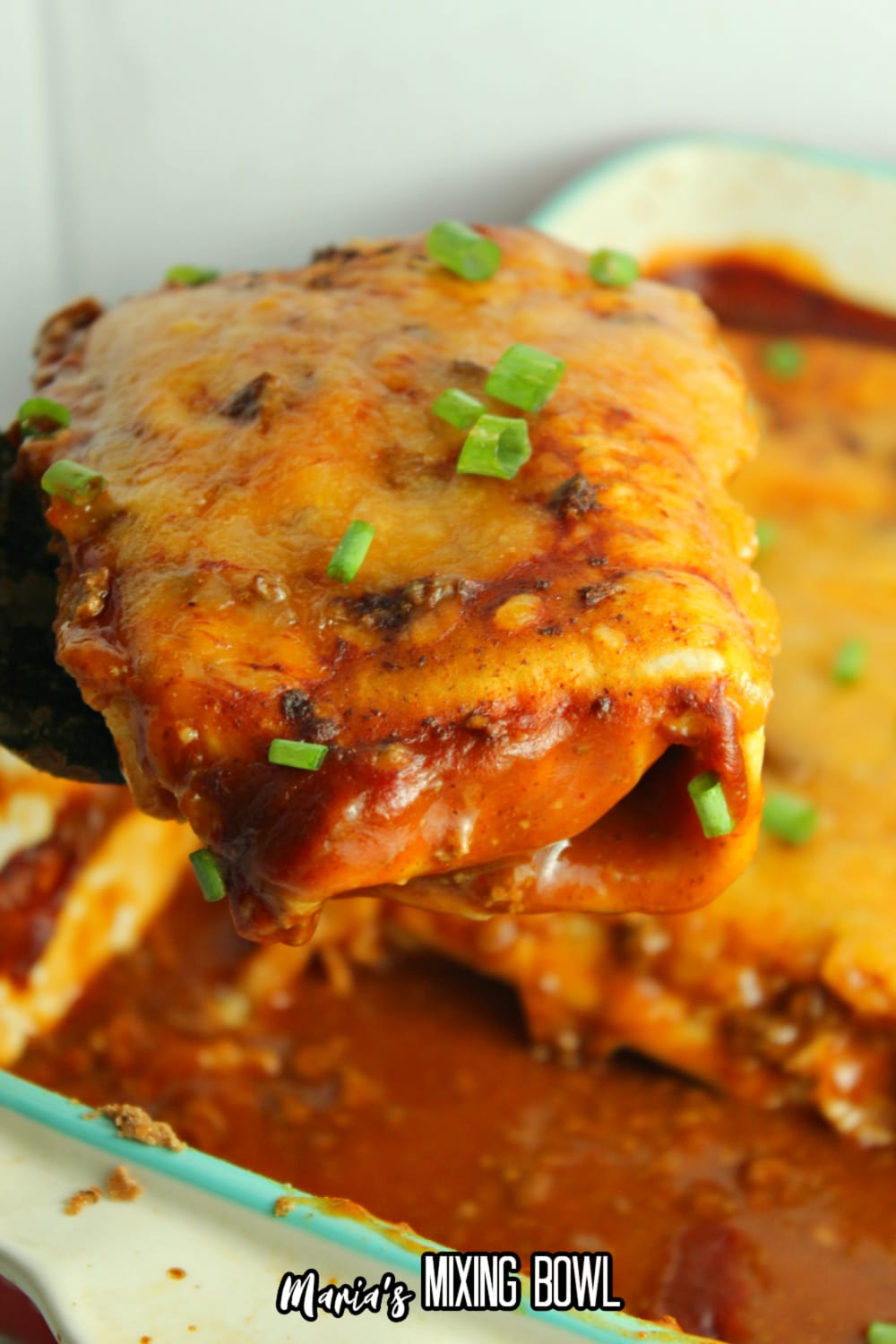 easy wet burritos on a spatula held in the air