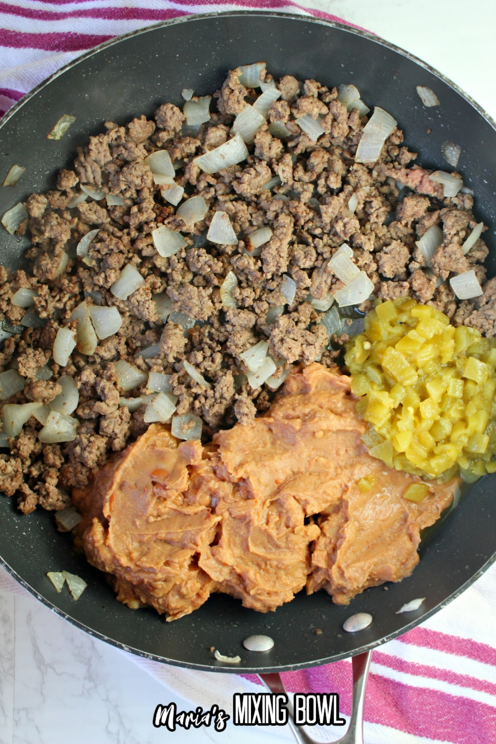 ground beef, beans, and onions in a large skillet