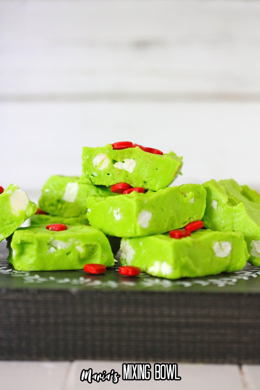 grinch fudge stacked in a pyramid on a wooden background