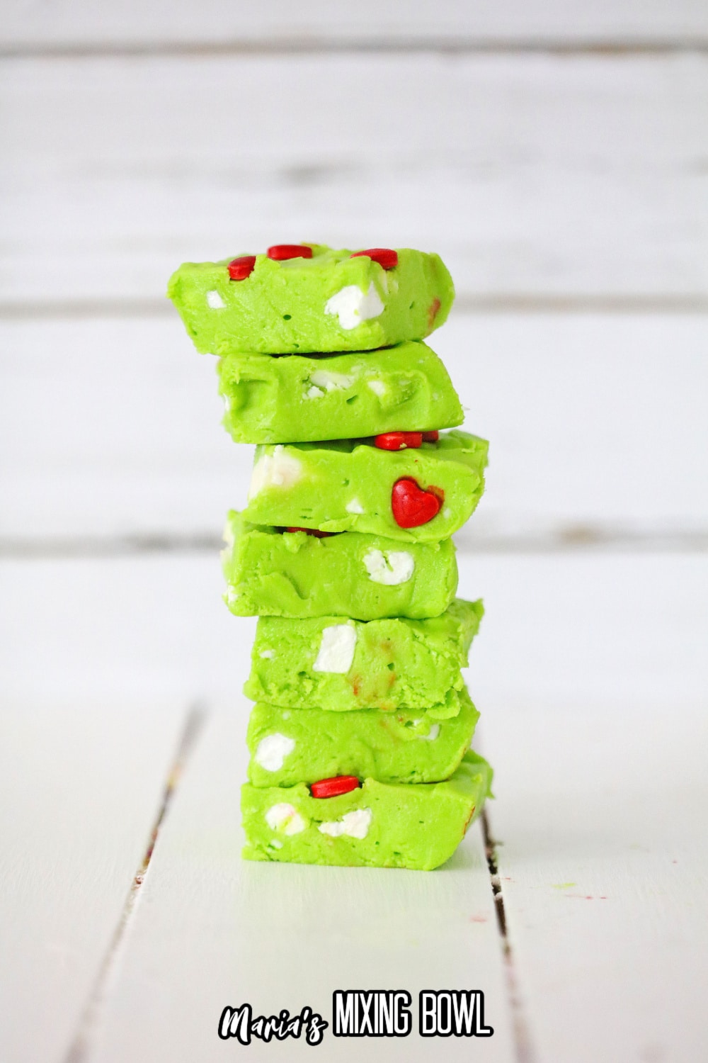 seven pieces of grinch fudge stacked on top of each other