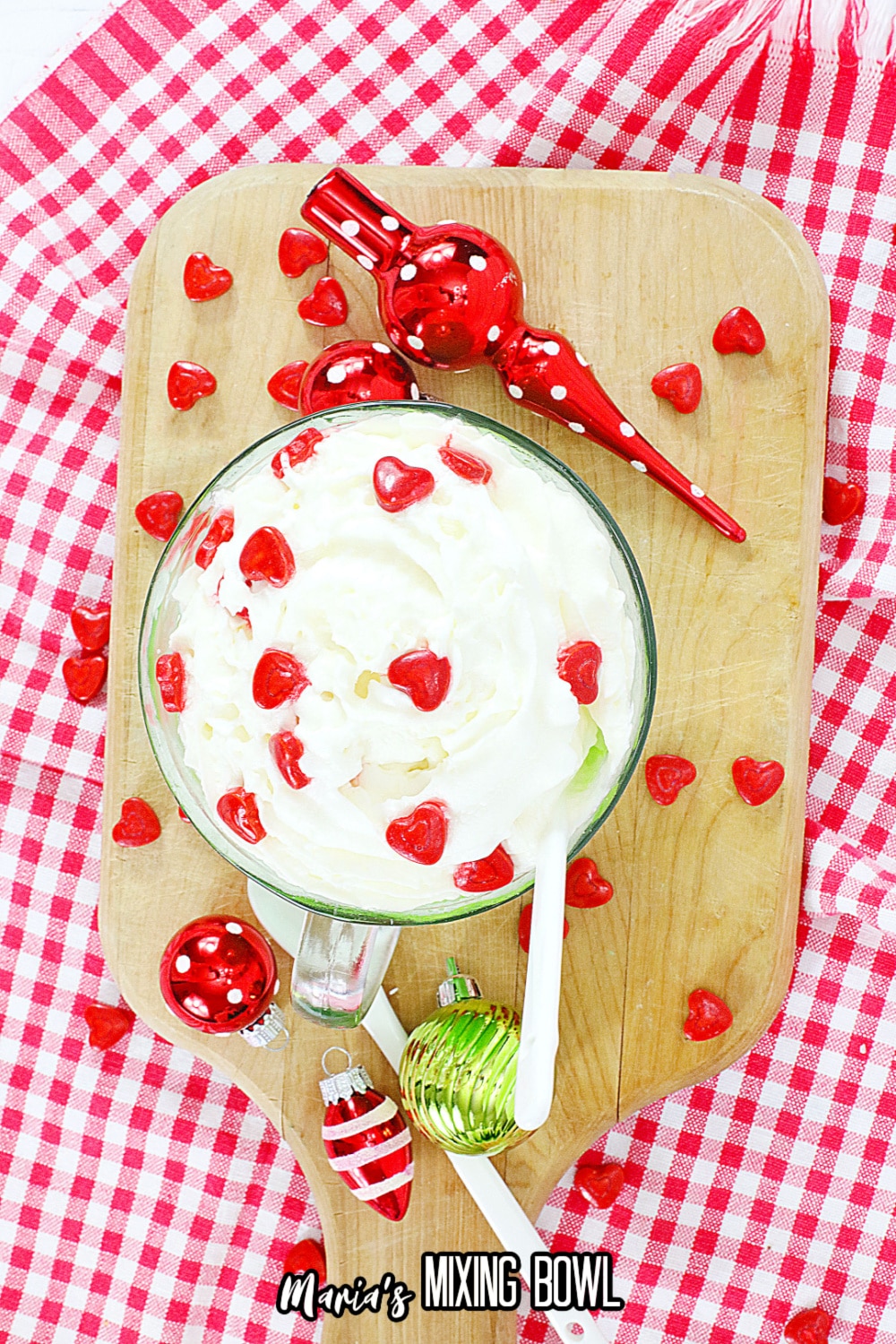 birds eye image of a grinch mug cake on a wooden cutting board