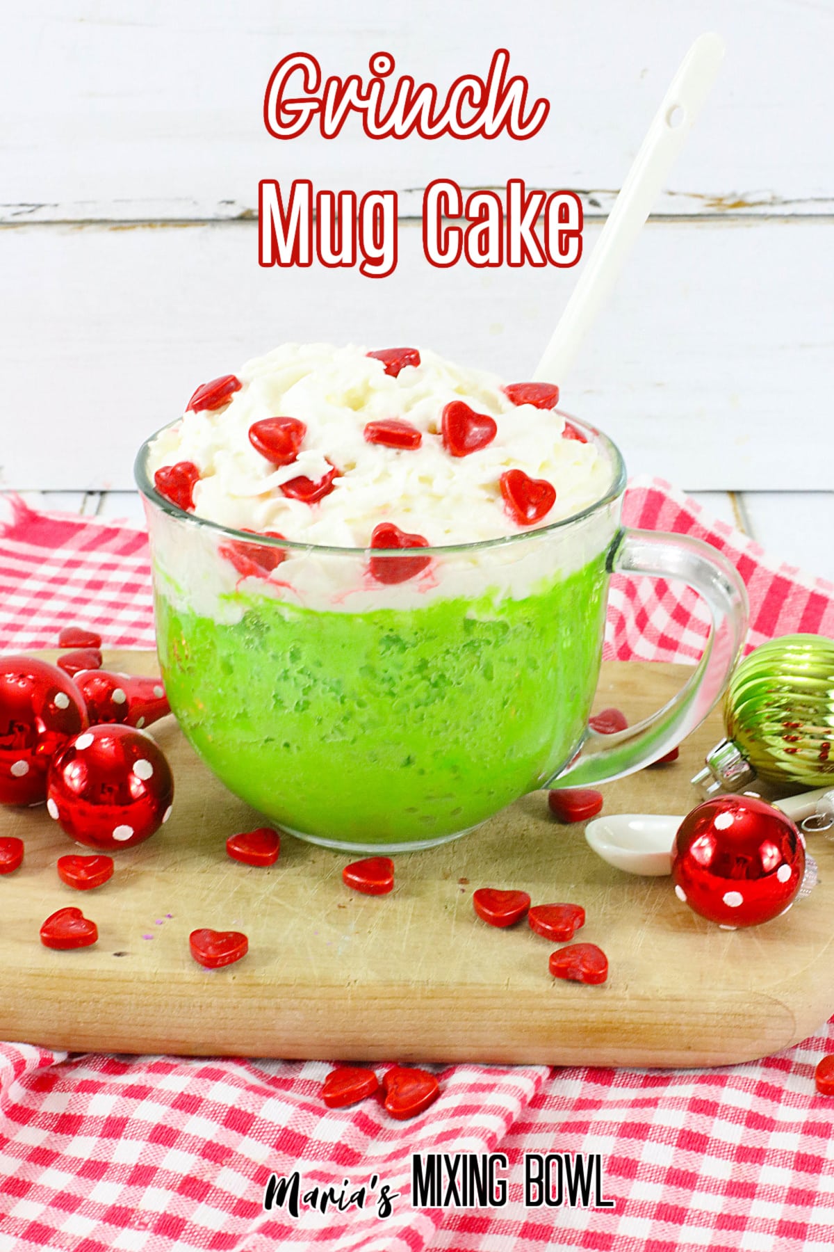 grinch mug cake on a wooden cutting board with the name in text