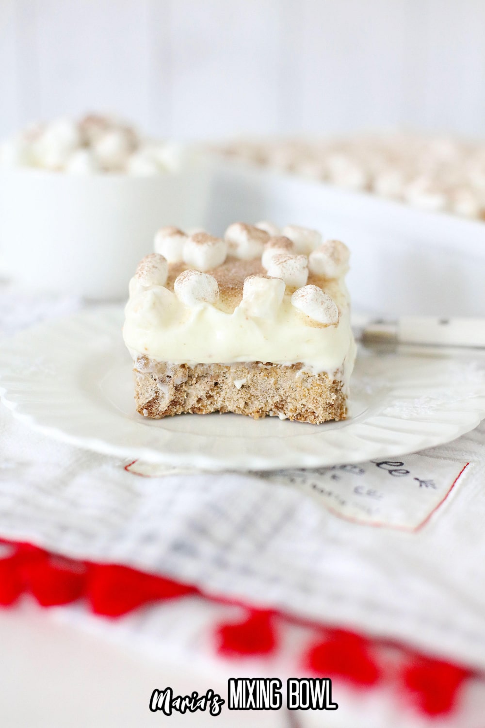 slice of hot cocoa cheesecake bar on a white plate