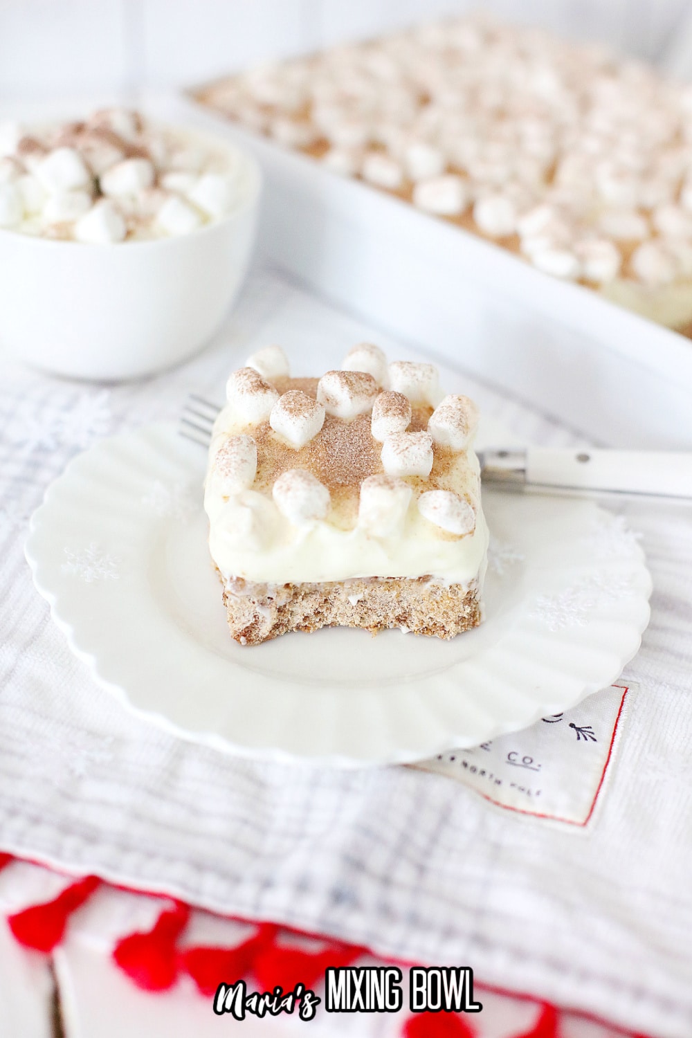 slice of hot cocoa cheesecake bar on a white plate