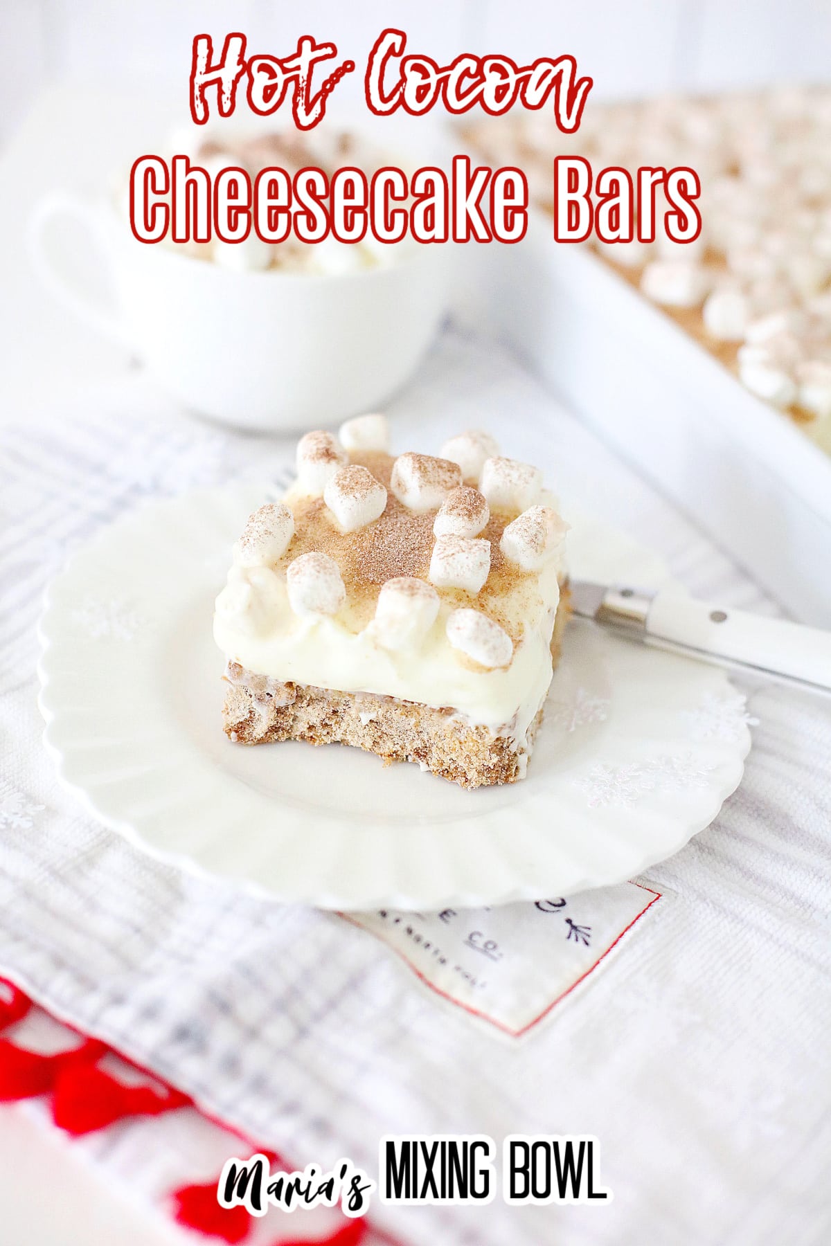 slice of hot cocoa cheesecake bar on a white plate with the name in text for pinterest