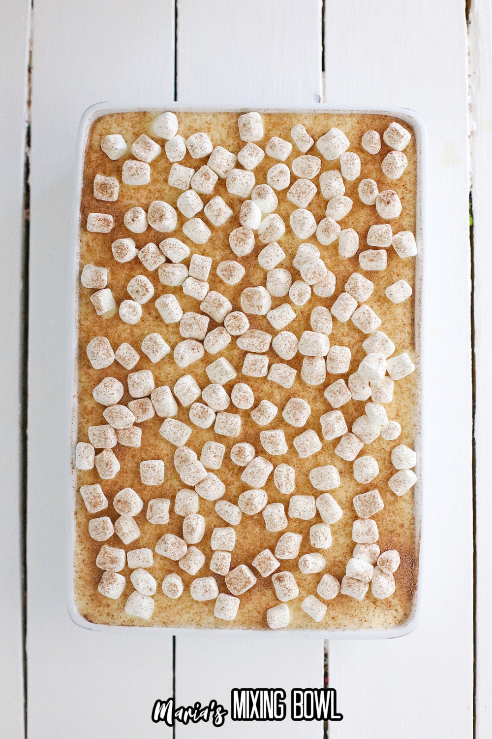 finished hot cocoa cheesecake bars in a white baking dish