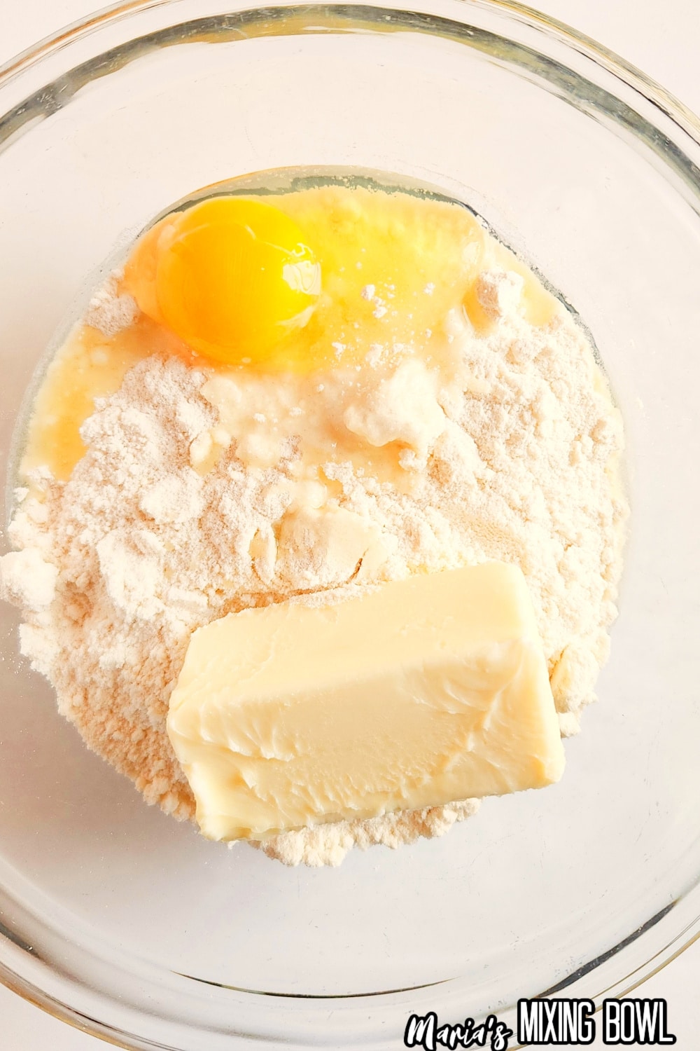 eggs,butter, and flour mixture in glass mixing bowl