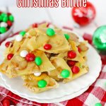 m&m christmas brittle stacked on a white plate with the name in text for pinterest
