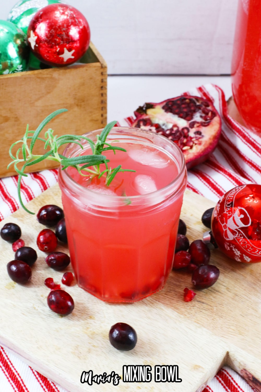 glass of rum cranberry punch on a wooden cutting board