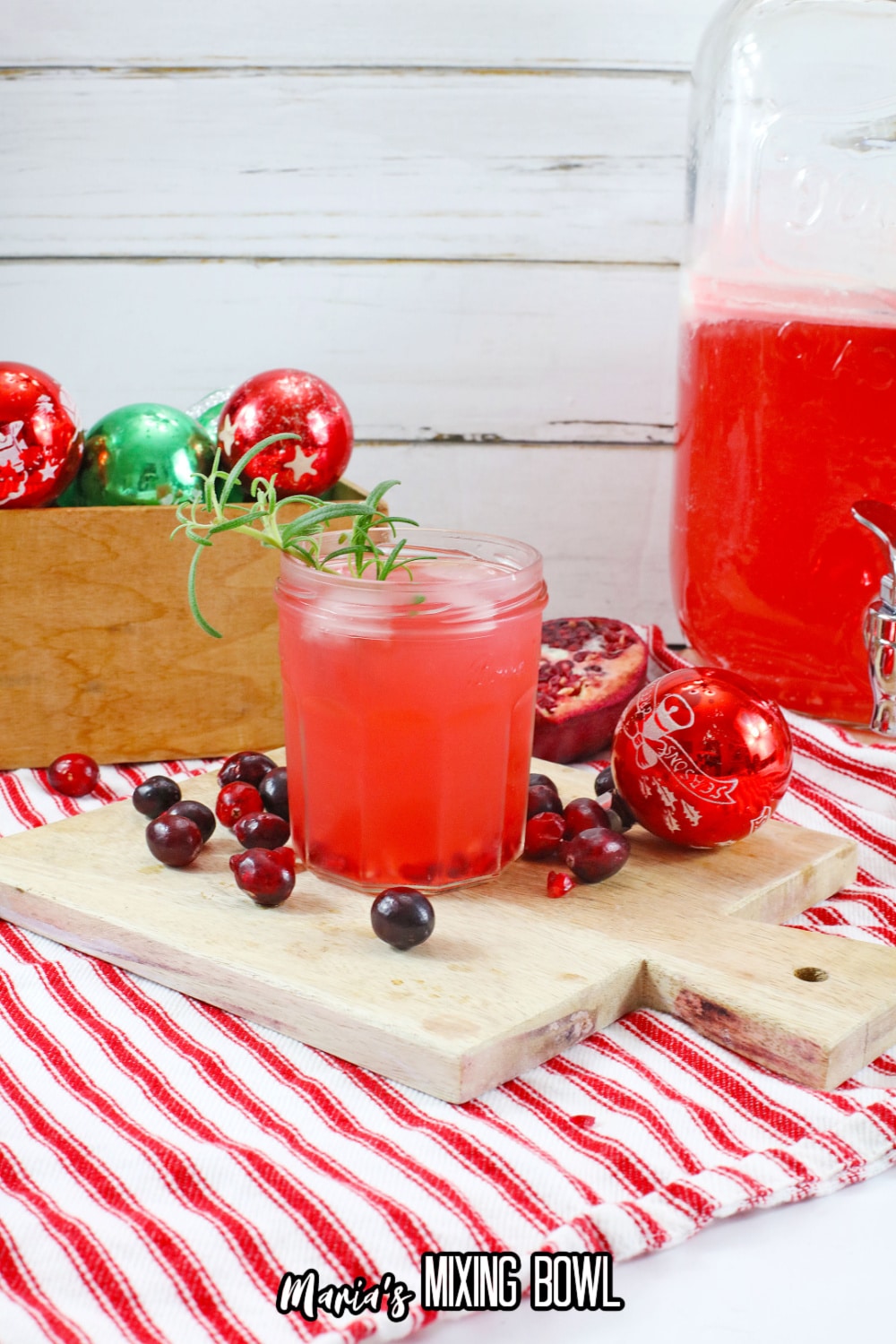 glass of rum cranberry punch on a wooden cutting board