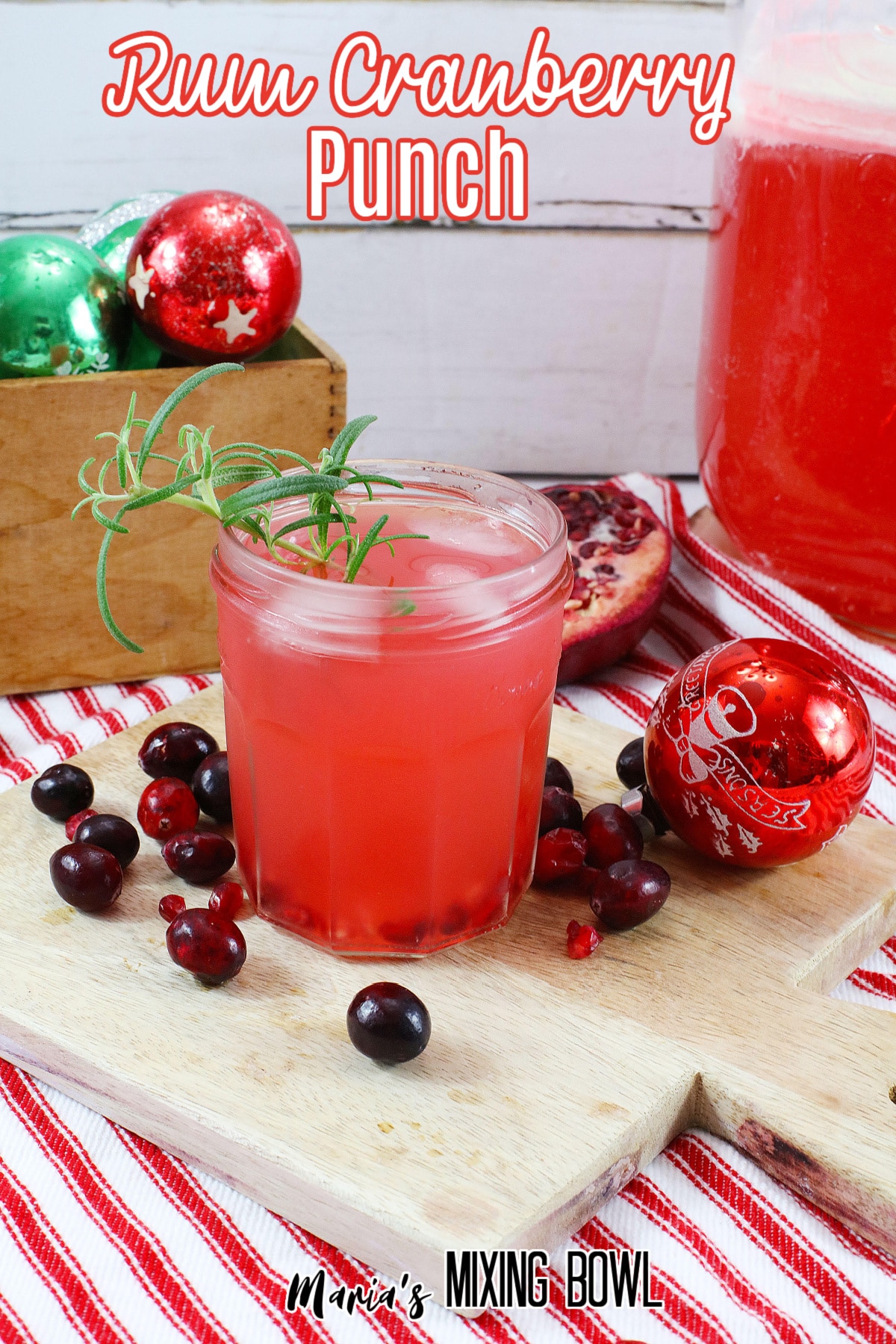 glass of rum cranberry punch on a wooden cutting board
