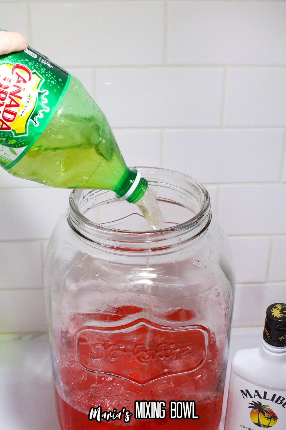 ginger ale being added to a mason jar
