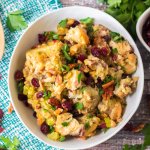 white bowl filled with slow cooker cranberry pecan stuffing