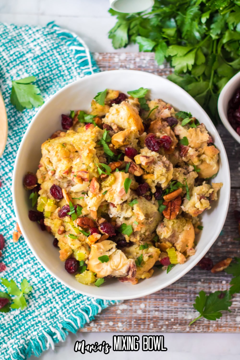 white bowl filled with slow cooker cranberry pecan stuffing