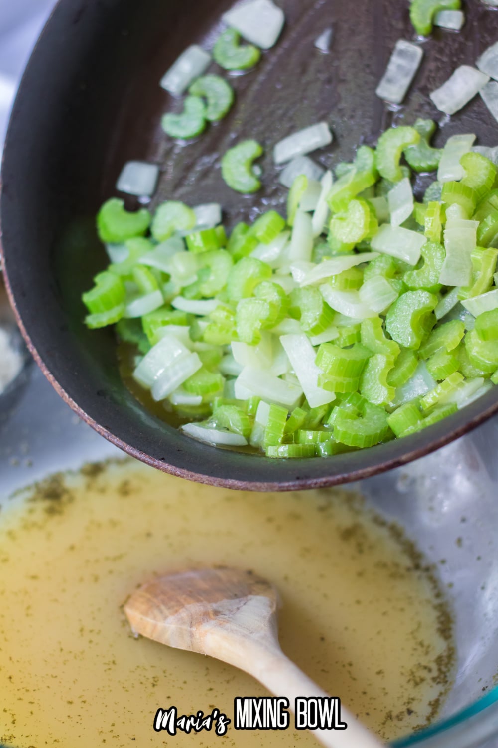 cooked celery and onions in a skillet