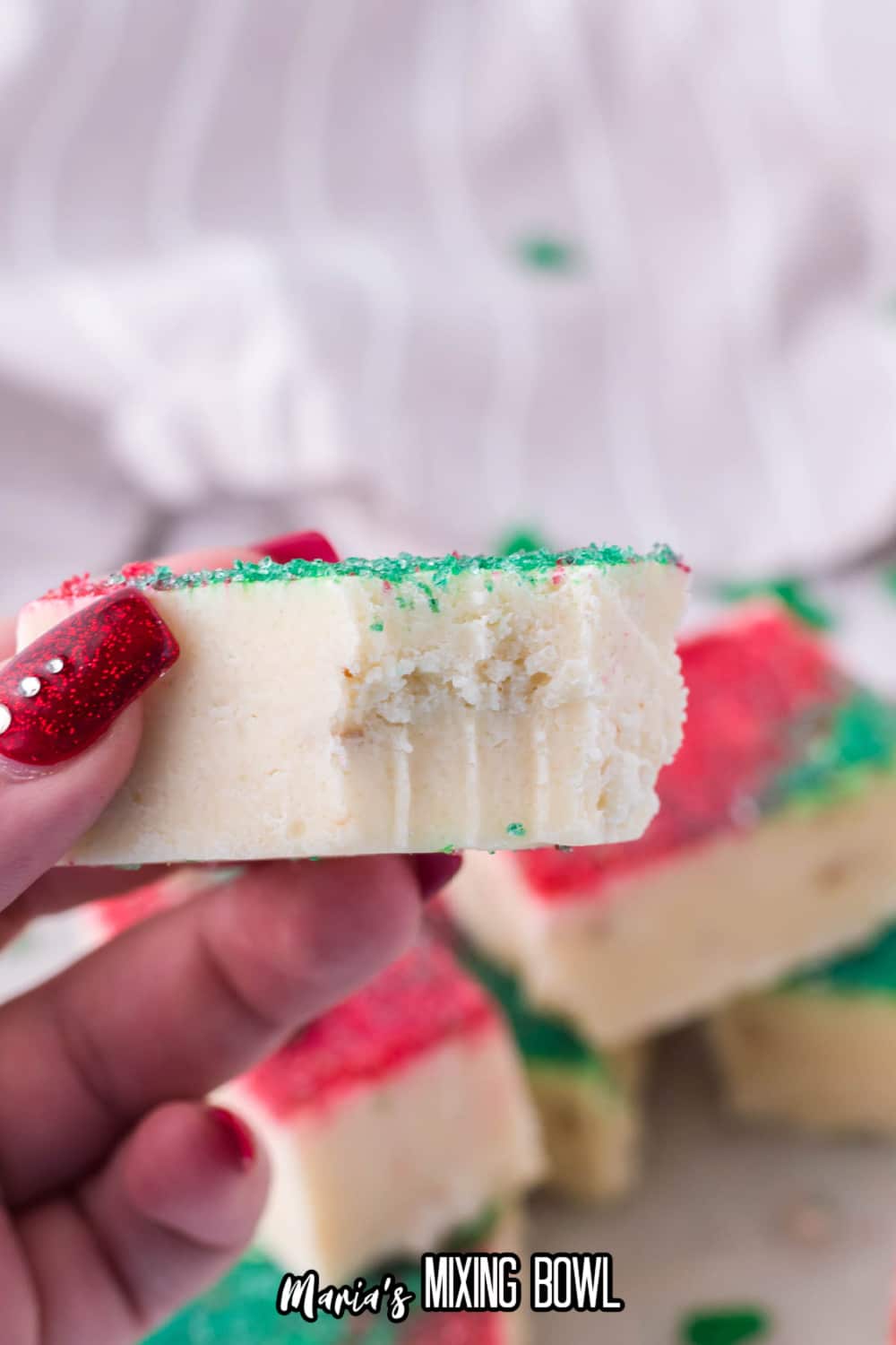 piece of sugar cookie fudge held in a womens hand