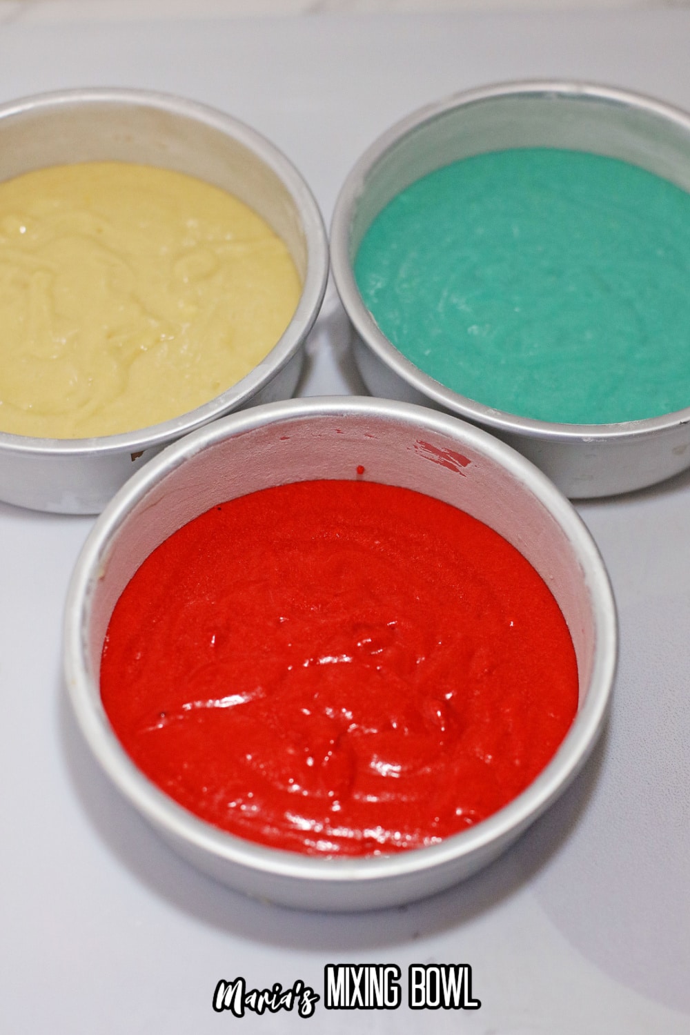 colored batter in three different pans