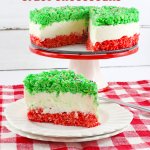 slice of christmas rice krispy crust cheesecake on a white plate with the name in text