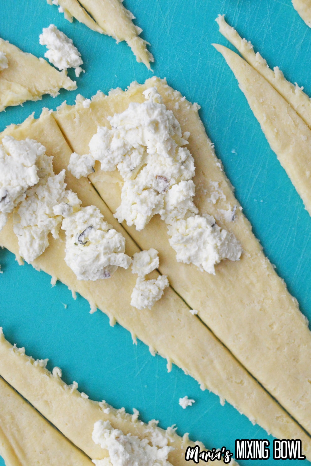 cheese on dough on a cutting board