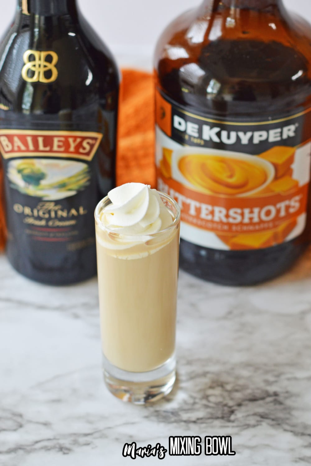single buttery nipple shot with buttershots and bailelys in the background