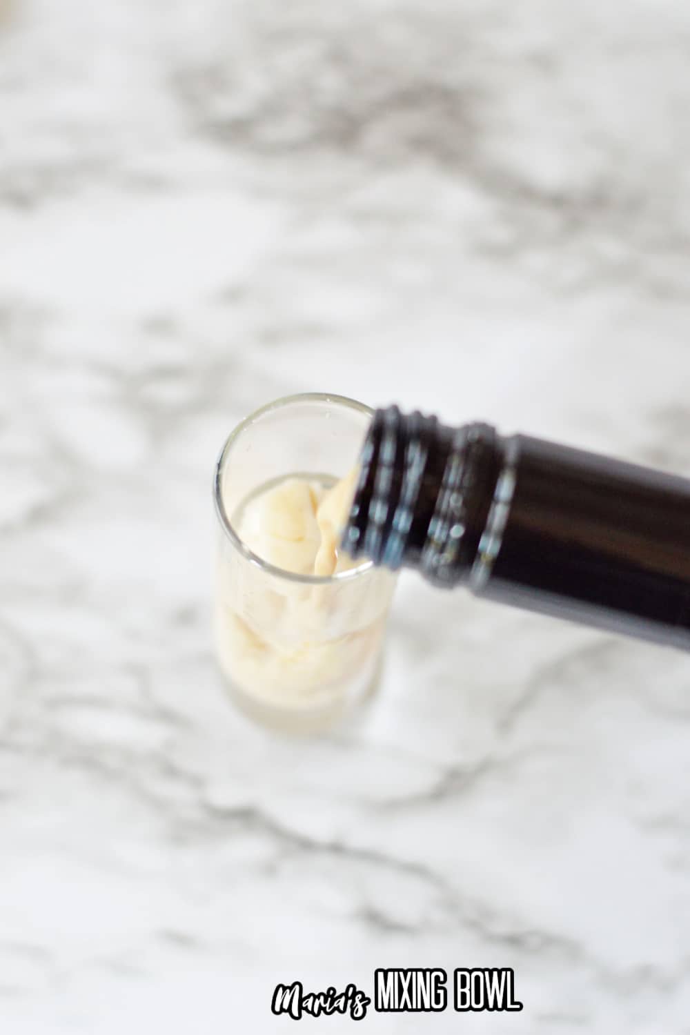 irish cream being poured into a shot glass