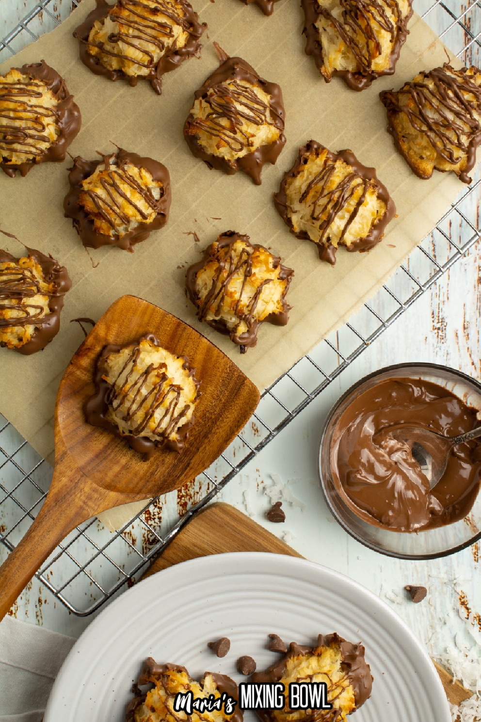 chocolate dipped cookies on a parchment lined cooling rack