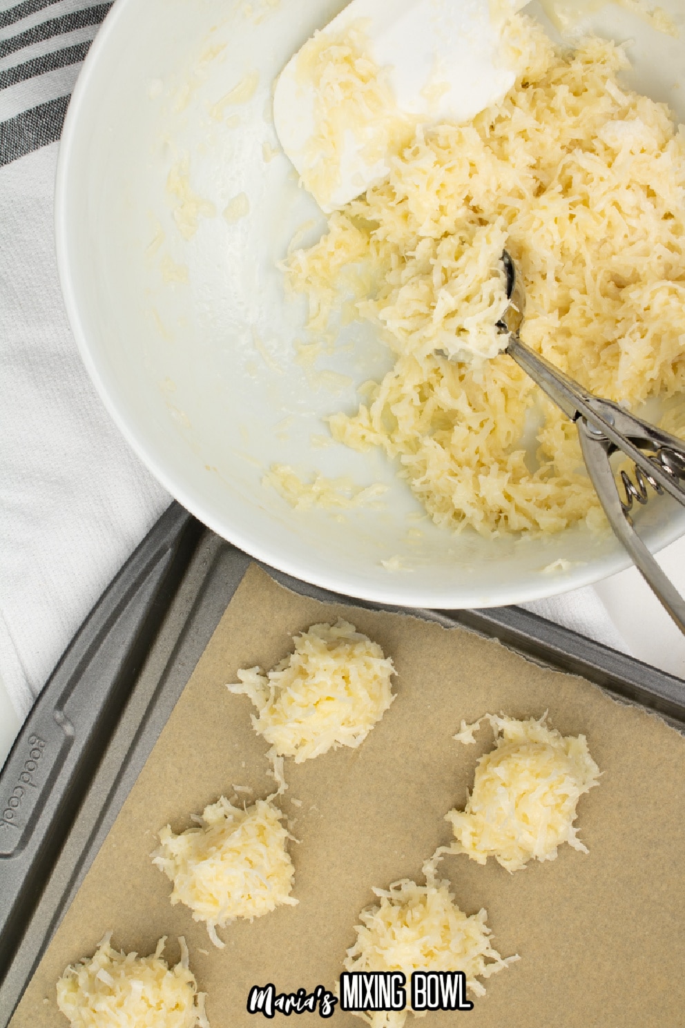 coconut mixture being scooped onto a parchment lined baking sheet