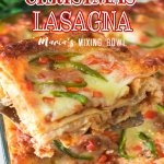 slice of christmas lasagna being held on a metal spatula in the air with the name in text for pinterest