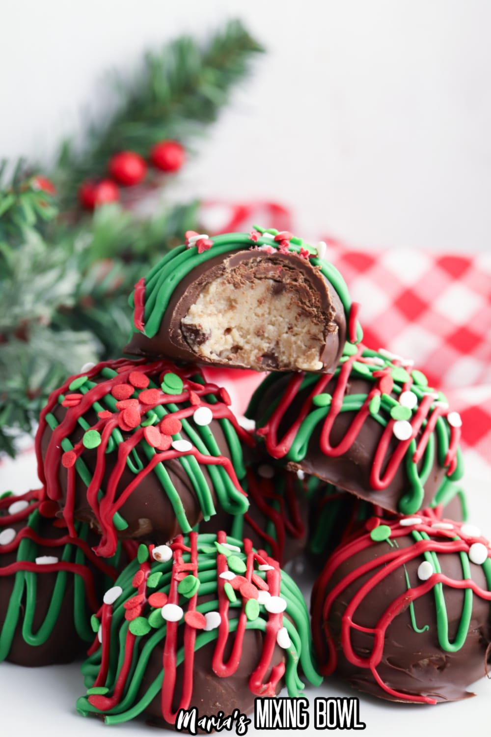 christmas no bake cookie dough bites stacked in a pyramid