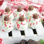 six christmas oreo balls on a white mini wooden pallet