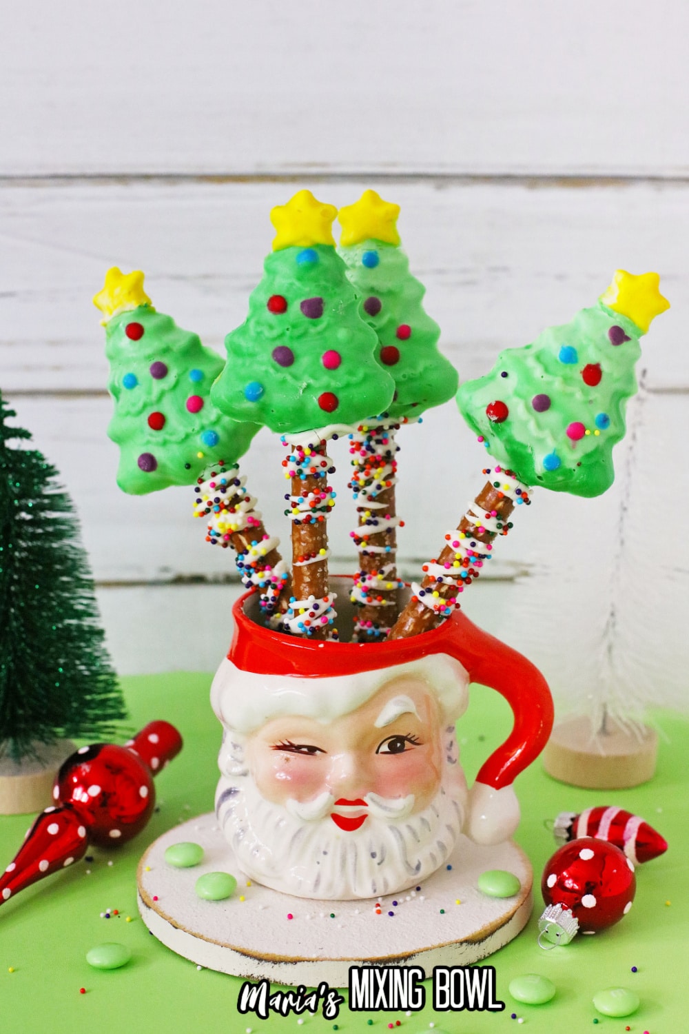 four christmas trees in a santa mug
