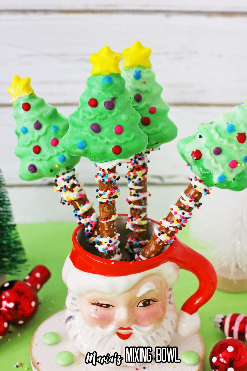 four christmas trees in a santa mug