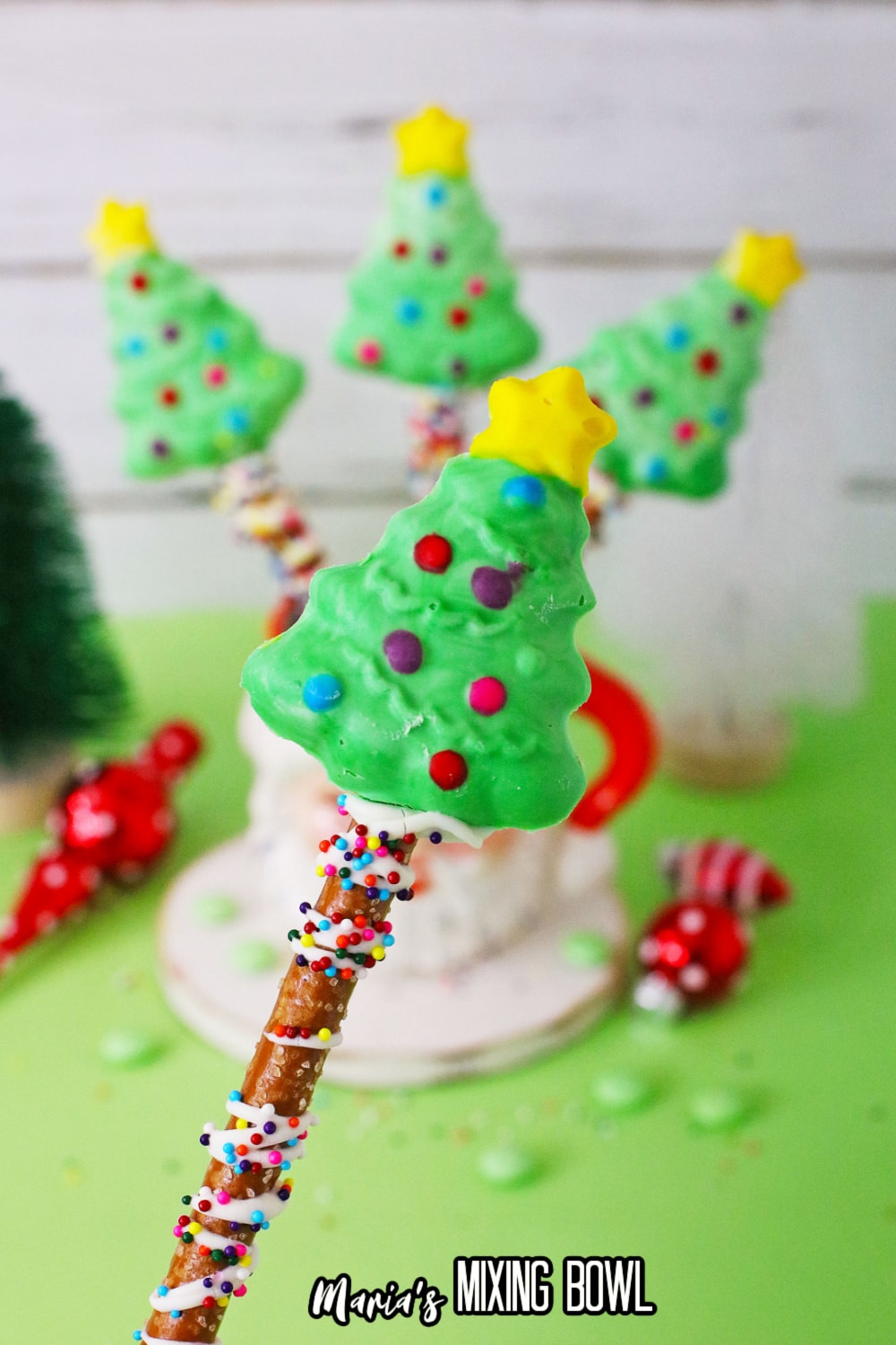 pretzel rod christmas tree being held in the air in front of the camera