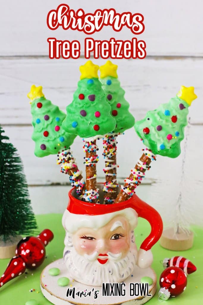 four christmas trees in a santa mug with the name in text for pinterest