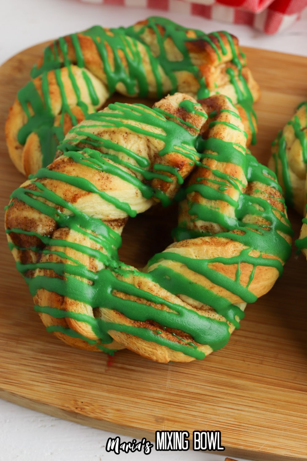 close up of a cinnamon roll wreath on a wooden cutting board