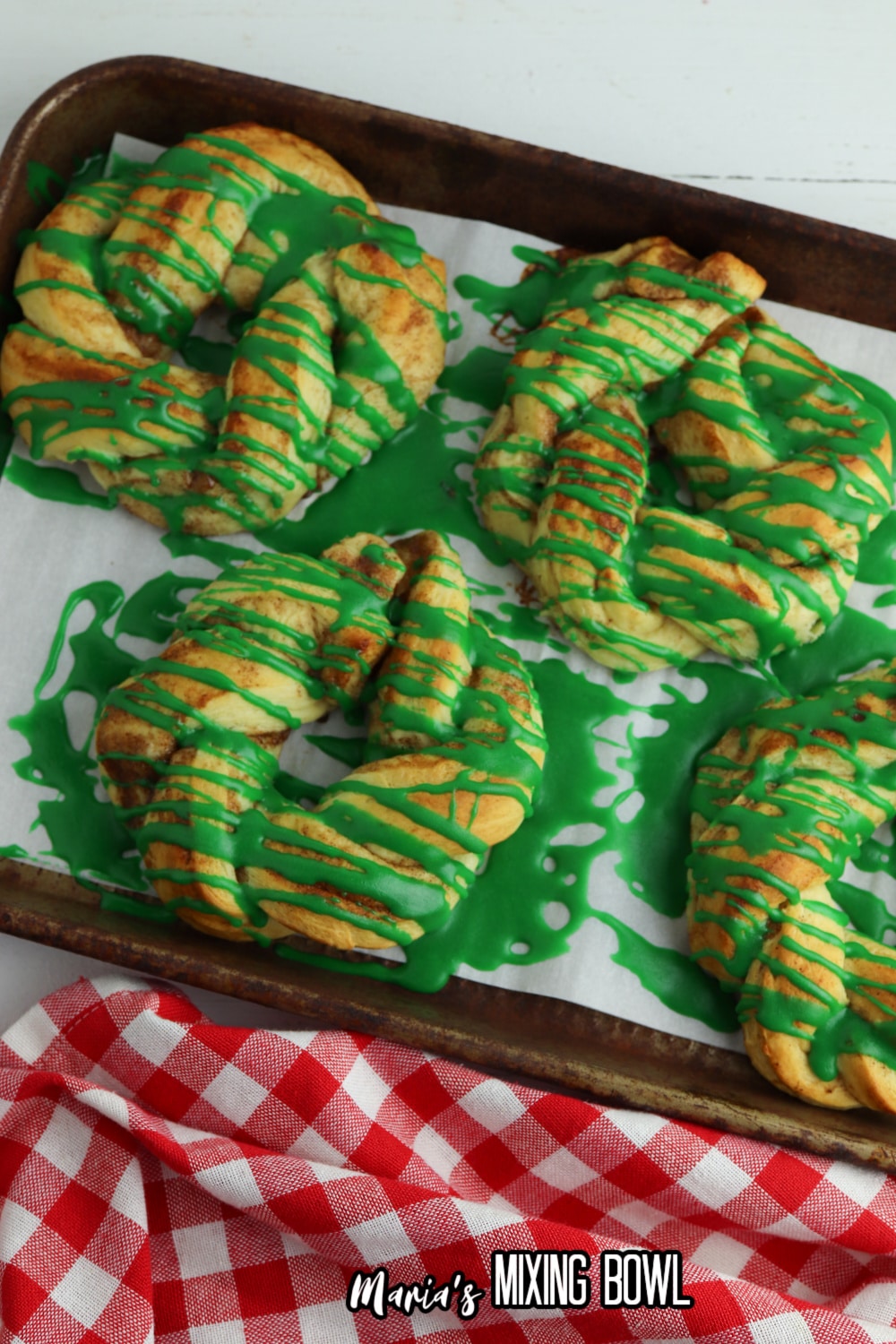 cinnanmon roll wreaths on a parchment lined baking sheet