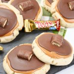 stack of twix cookies on a wooden board