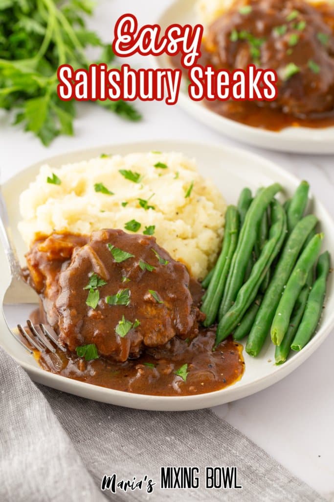 salisbury steaks with green beans and mashed potatoes on a white plate with the name in text for pinterest