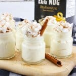 eggnog pudding shots on a wooden cutting board