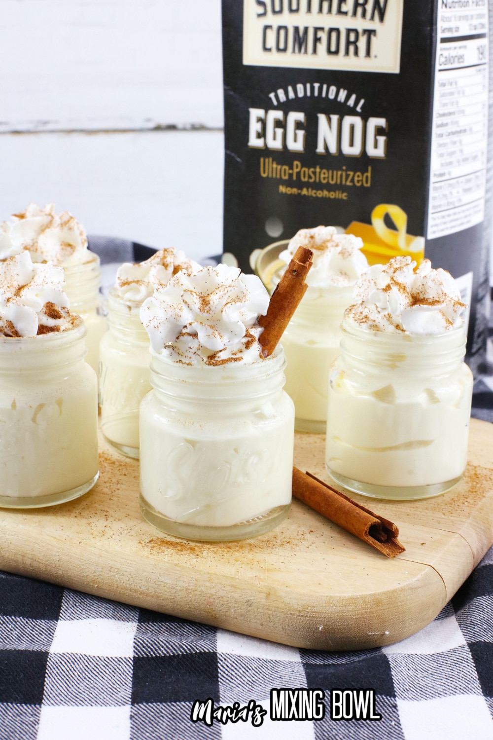 eggnog pudding shots on a wooden cutting board