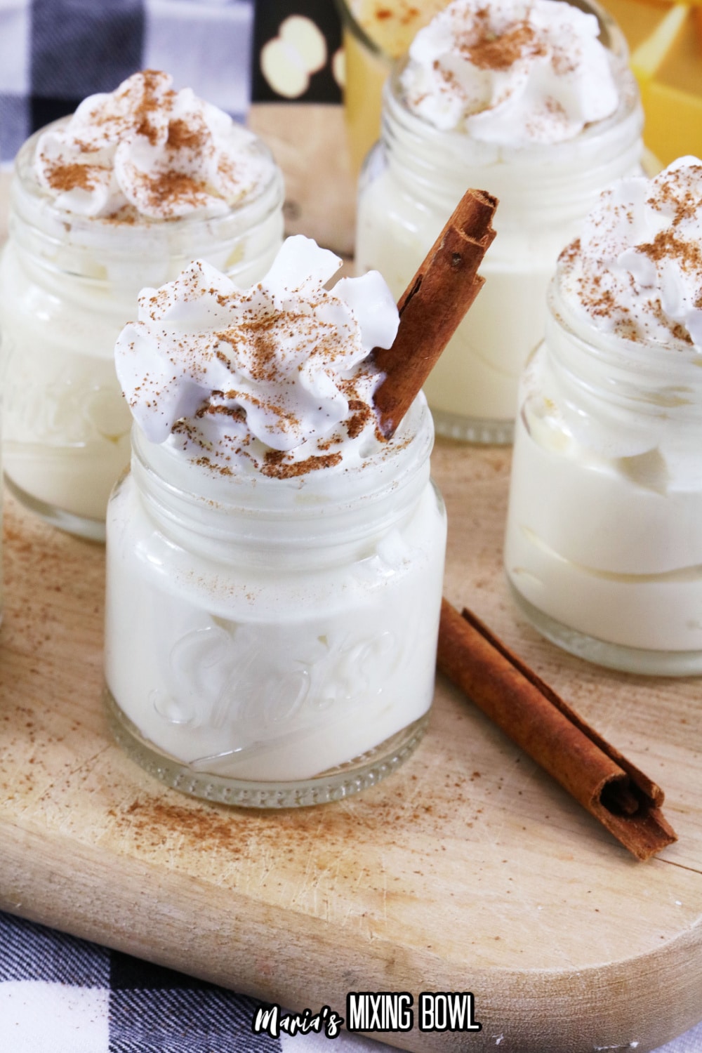 eggnog pudding shots on a wooden cutting board