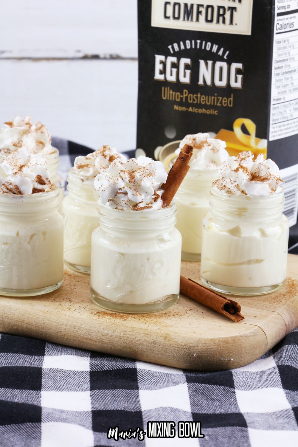 eggnog pudding shots on a wooden cutting board