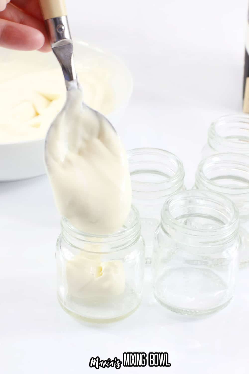 pudding being put into small mason jars