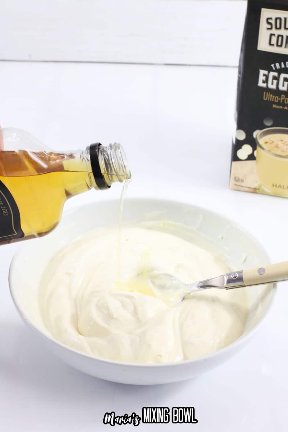pudding and jack daniels being added into a small bowl