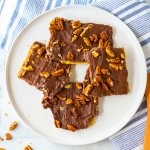 four pieces of graham cracker toffee bark on a white plate