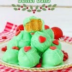 grinch peanut butter balls stacked on a white plate with gold rimmed edges with the name in next for pinterest