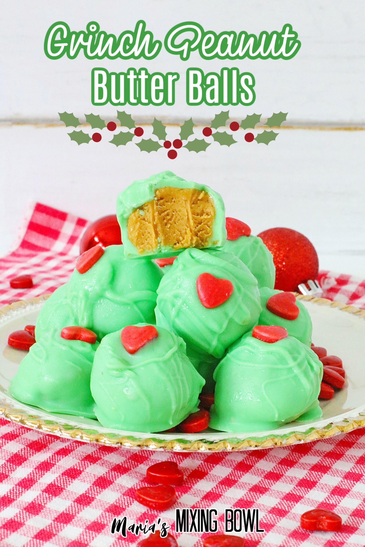 grinch peanut butter balls stacked on a white plate with gold rimmed edges with the name in next for pinterest